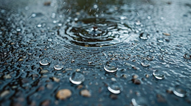 Rain Drop Ripples On The Blue Water