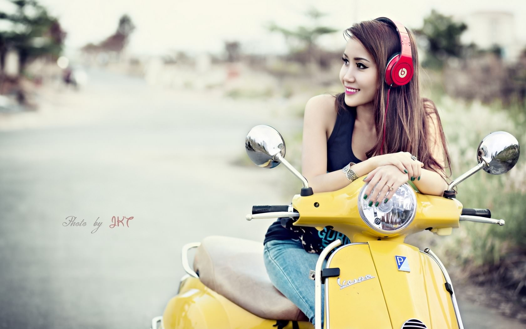 Asian Girl Smiling on Scooter with Headphones