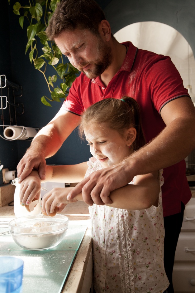 Father Helping His Daughter Cook
